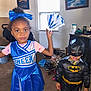 Mercedes joined the competition — help win amazing prizes! child, children, costume, cheerleader, batman, indoor, carpet, window, shoes, mask, blue, black, yellow, toy, dress, person, smile, hair, decor, room