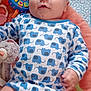 baby, infant, onesie, elephant_pattern, toy, teether, plush_toy, blanket, bed, phone_home_screen, app_icons, portrait, close_up, blue, white, chubby_legs, hand, eyes, lying_down, cute