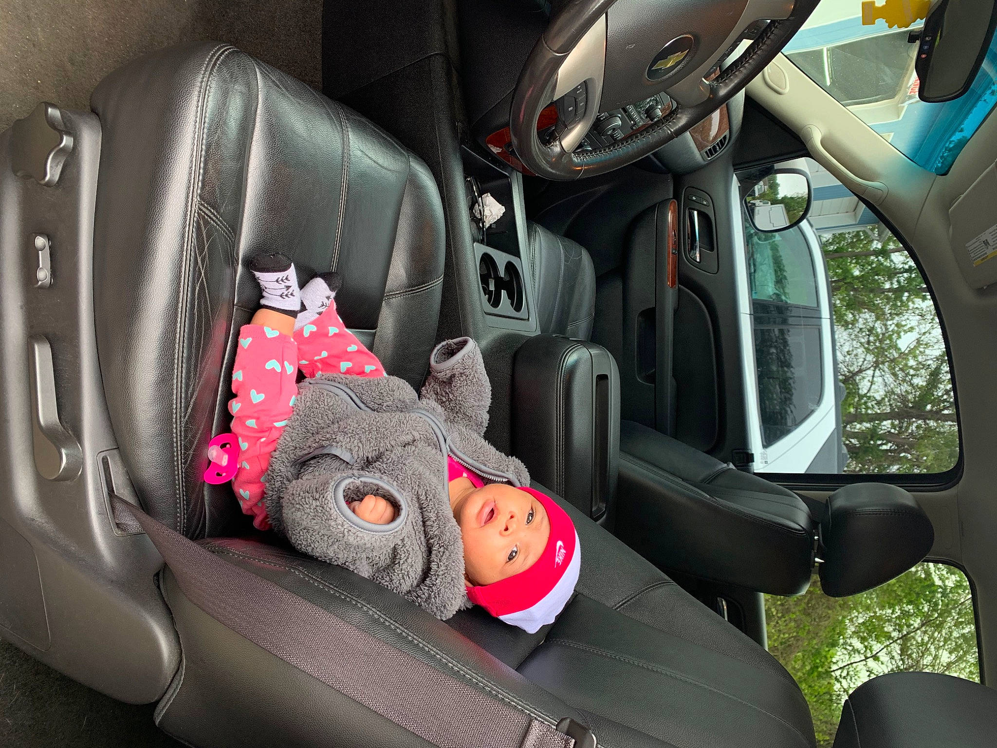 Royalty is registered to the contest to win money with this photo: auto_part, baby_in_car_seat, car, car_seat, car_seat_cover, family_car, head_restraint, headwear, passenger, person, seat_belt, vehicle, vehicle_door
