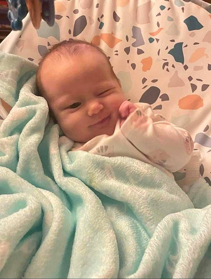 Dahlia is registered to the contest to win money with this photo: baby, baby_toddler_clothing, bedding, bedtime, blanket, cheek, child, comfort, linens, pattern, peach, person, room, skin, sleeve, toddler