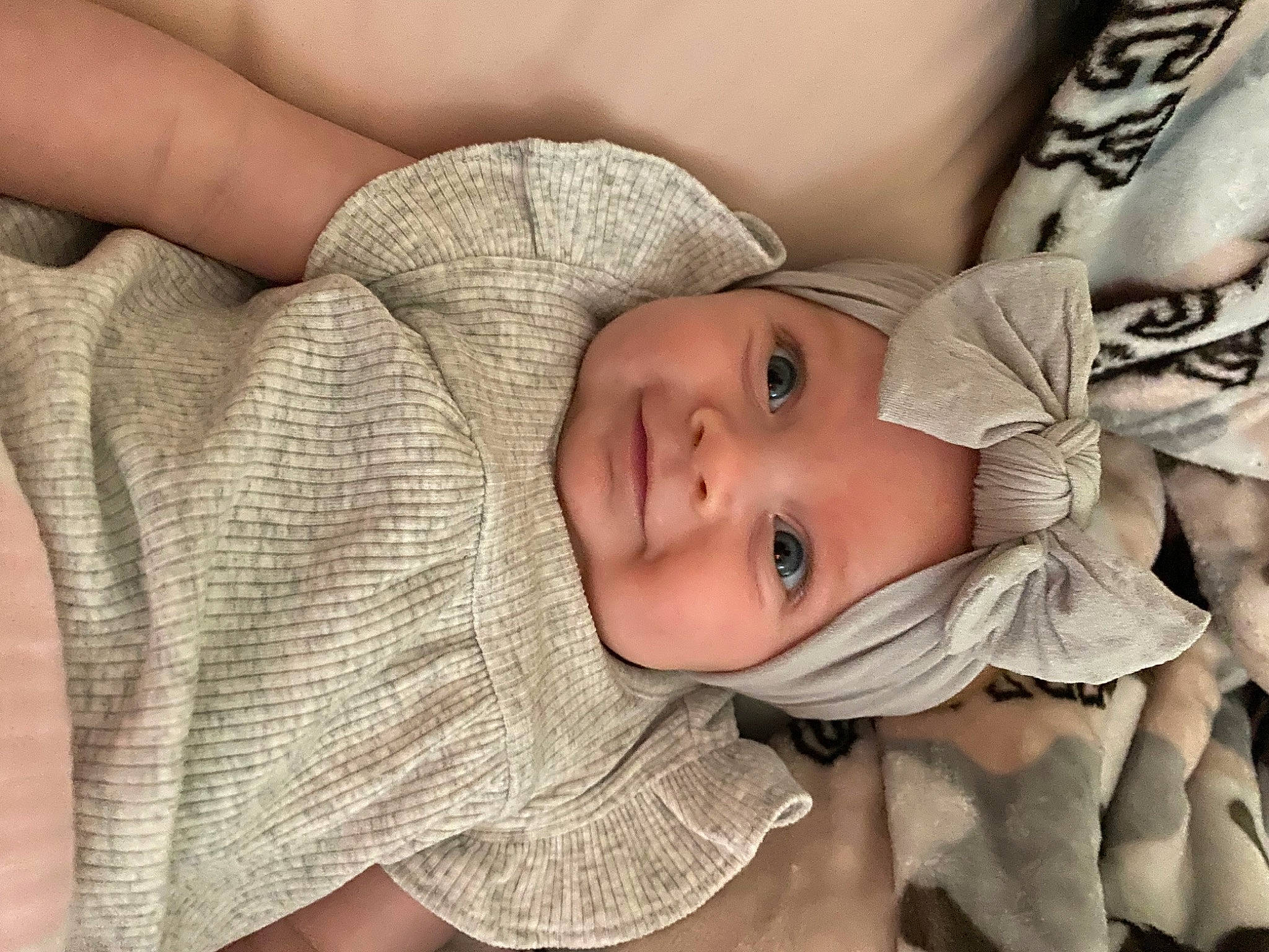 Charlee is registered to the contest to win money with this photo: arm, baby, baby_toddler_clothing, cheek, chin, comfort, eye, eyebrow, face, facial_expression, head, headwear, human_body, iris, joy, lip, mouth, nose, person, skin