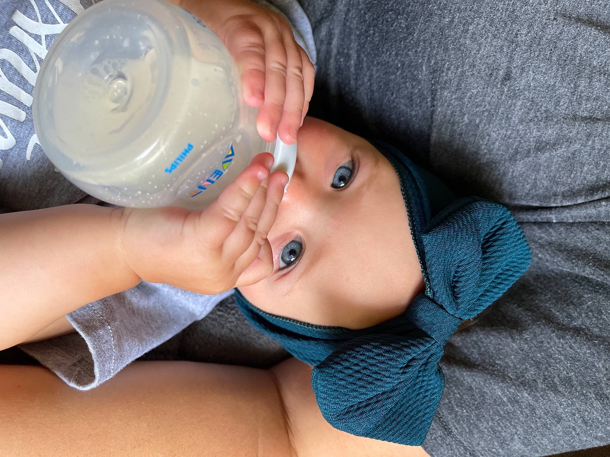 Harleigh is registered to the contest to win money with this photo: baby, baby_bottle, bottle, comfort, drinking, drinking_water, drinkware, electric_blue, eyelash, finger, food, gesture, hand, mineral_water, nail, person, plastic_bottle, skin, thumb, toddler