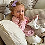 Alma participe au concours pour gagner de l'argent avec cette photo : toddler, child, thumb_sucking, purple_bow, pink_sweater, white_pants, plush_toy, blanket, pillows, soft_fabric, indoor, couch, cute, comfort, relaxed, portrait, young_child, cozy, seated, innocence