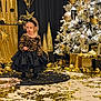 Alma a rejoint le concours — aidez-le/la à gagner de superbes lots ! toddler, child, holiday, christmas_tree, gold, black, sparkle, decorations, festive, dress, sequins, headband, presents, confetti, indoor, celebration, curly_hair, floor, portrait, lighting