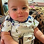 Charlotte is registered to the contest to win money with this photo: baby, infant, child, onesie, cartoon_print, leopard_print, leggings, hand, face, skin, indoors, person, cute, smile, plush, seated, clothing, expression, portrait, cozy