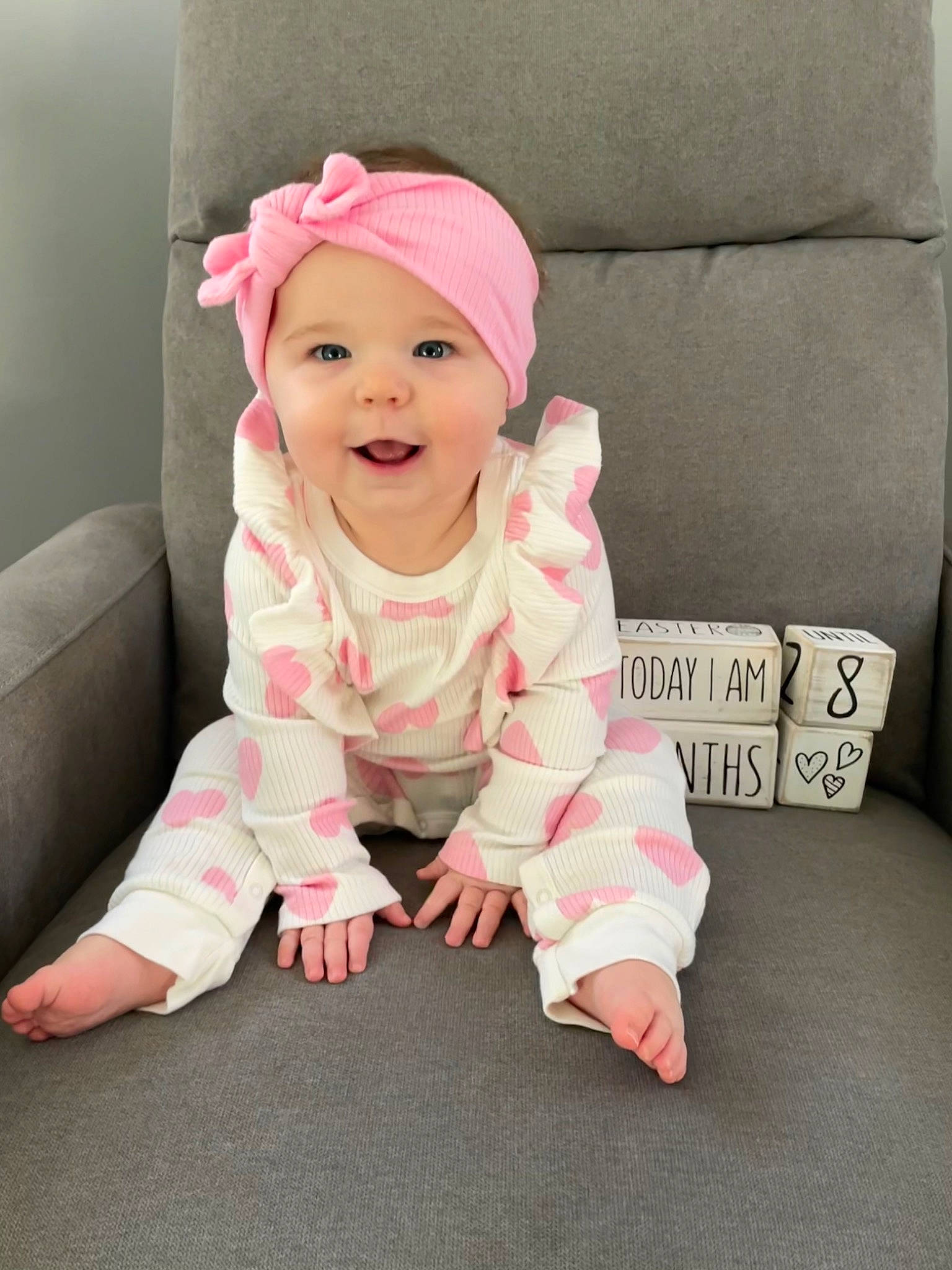 Emersyn joined the competition — help win amazing prizes! baby, baby_toddler_clothing, cap, cheek, child, clothing, comfort, couch, eye, flooring, happy, head, headgear, headwear, joy, lip, magenta, person, pink, skin