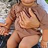 Joseph joined the competition — help win amazing prizes! toddler, child, curly_hair, outdoor, adult, holding, plaid_pants, graphic_tshirt, socks, sunny, grass, building, person, lap, casual_clothing, daylight, skin, face, expression, seated