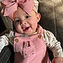 baby, child, pink_bow, overalls, bunny_pocket, smiling, happy, cute, indoor, leather_chair, clothing, portrait, infant, headband, face, person, toddler, apparel, seated, adorable