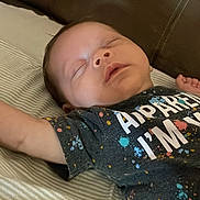 Zaydyn joined the competition — help win amazing prizes! baby, sleeping, child, tshirt, colorful, bed, striped_sheet, arm, face, peaceful, indoors, childhood, infant, rest, portrait, cute, person, lying_down, young, sleep