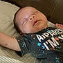 baby, sleeping, child, tshirt, colorful, bed, striped_sheet, arm, face, peaceful, indoors, childhood, infant, rest, portrait, cute, person, lying_down, young, sleep