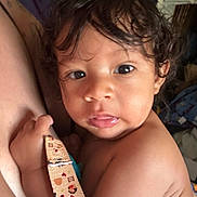 Malcolm Jr is registered to the contest to win money with this photo: baby, child, face, skin, hair, hand, curly_hair, closeup, person, infant, cute, expression, indoor, strap, holding, portrait, young, human, looking, soft