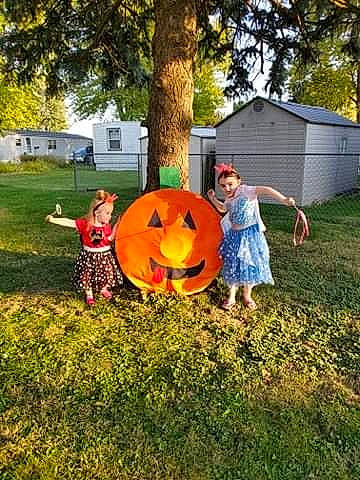 Kamryn is registered to the contest to win money with this photo: backyard, blurred, child, costume, fun, games, garden, grass, lawn, leaf, person, plant, play, pumpkin, smile, toddler, tree, winter_squash, yard