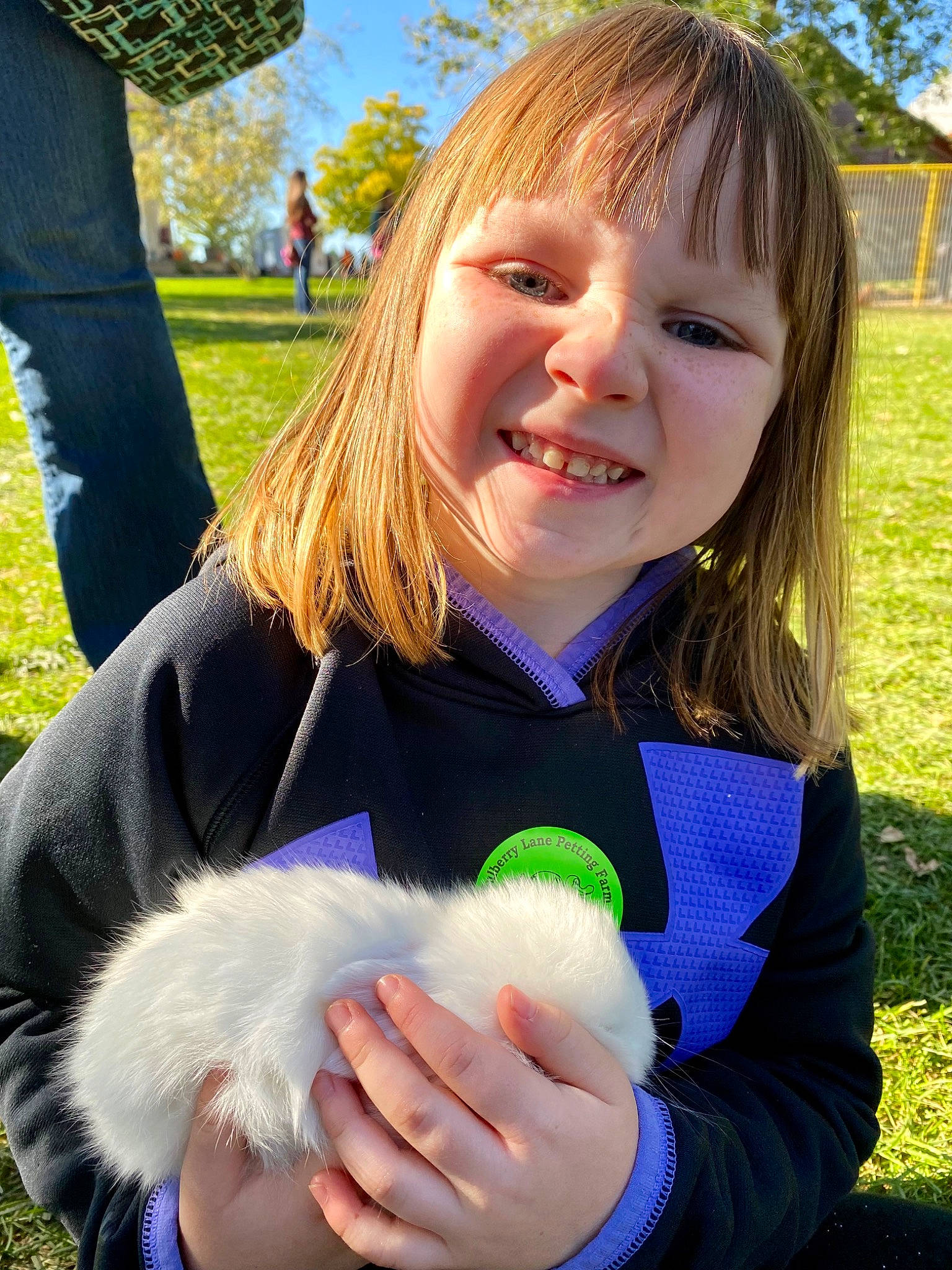 Evalyn is registered to the contest to win money with this photo: blond, child, electric_blue, eye, face, fun, gesture, glove, grass, hand, happy, iris, joy, leisure, people_in_nature, person, sitting, skin, smile, thumb