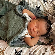 Leo joined the competition — help win amazing prizes! newborn, baby, sleeping, blanket, quilt, star_pattern, infant, resting, peaceful, soft_texture, bed, cute, child, wrapped, indoors, comfortable, toddler, face, skin, hair