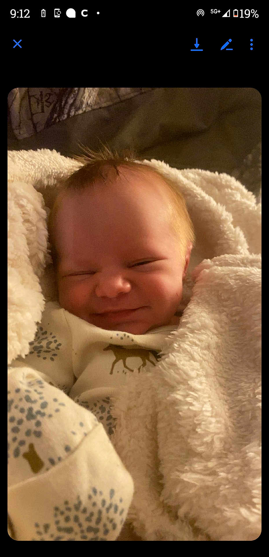 Lucas joined the competition — help win amazing prizes! baby, infant, blanket, smile, sleepy, cozy, face, clothing, cute, newborn, soft, warm, happy, resting, child, indoors, person, portrait, snuggled, sleep