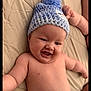 baby, infant, smiling, hat, blue_hat, knitted_hat, pom_pom, diaper, bed, bedding, beige, cute, happy, chubby, lying_down, baby_arm, baby_face, skin, child, indoors