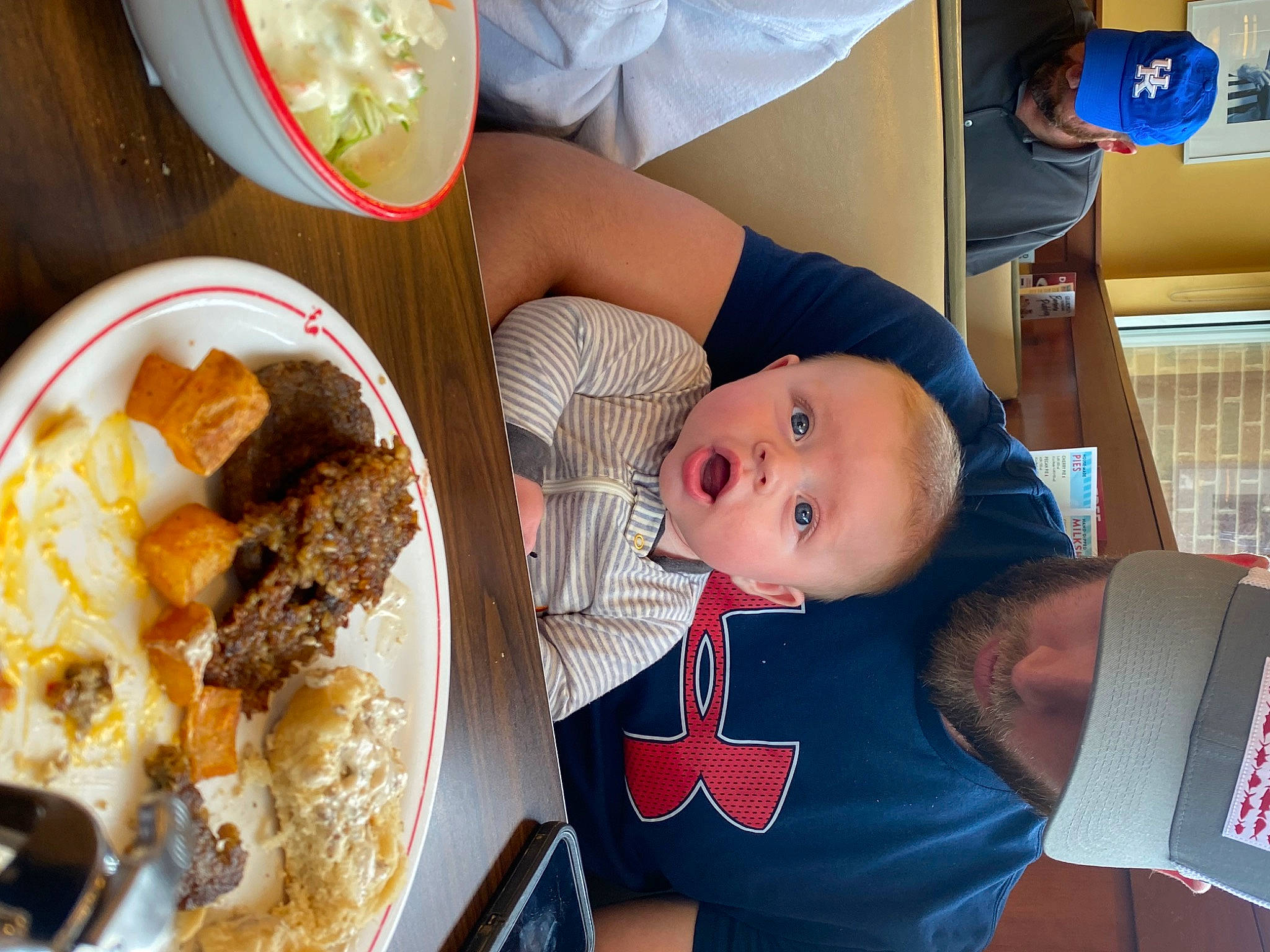 Layton is registered to the contest to win money with this photo: baby, bowl, comfort_food, cuisine, dairy, dish, dishware, food, fork, hat, headwear, ingredient, kitchen_utensil, person, plate, recipe, serveware, spoon, surprise, t_shirt