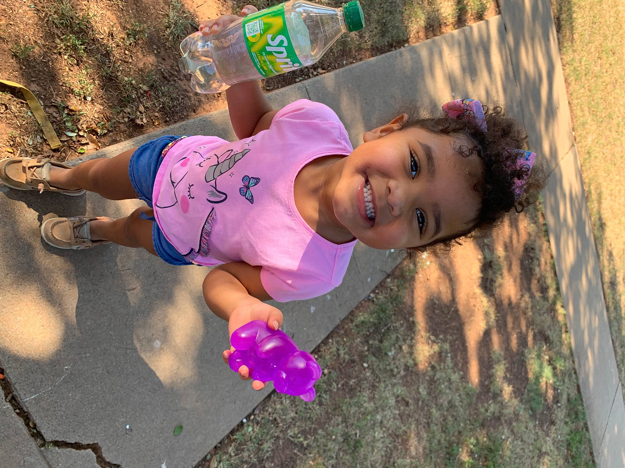 Kamyah is registered to the contest to win money with this photo: child, fun, grass, happy, hat, human_leg, joy, leisure, magenta, people_in_nature, person, pink, play, purple, recreation, sand, sandal, smile, soil, thigh