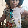 Willow is registered to the contest to win money with this photo: background, bucket_hat, casual_clothing, child, cute, daylight, expression, fun, girl, hat, nature, outdoor, person, portrait, pout, princess, sunglasses, sunhat, tshirt, young_child