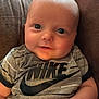 Zander joined the competition — help win amazing prizes! child, baby, infant, portrait, close_up, smiling, eyes, face, t_shirt, brand_logo, nike, clothing, arm, hand, couch, indoor, soft_lighting, furniture, table, adorable