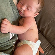 Knox is registered to the contest to win money with this photo: adult, baby, blanket, closeup, clothing, comfort, couch, diaper, face, hand, holding, indoor, infant, nap, person, relaxation, rest, skin, sleeping, toddler