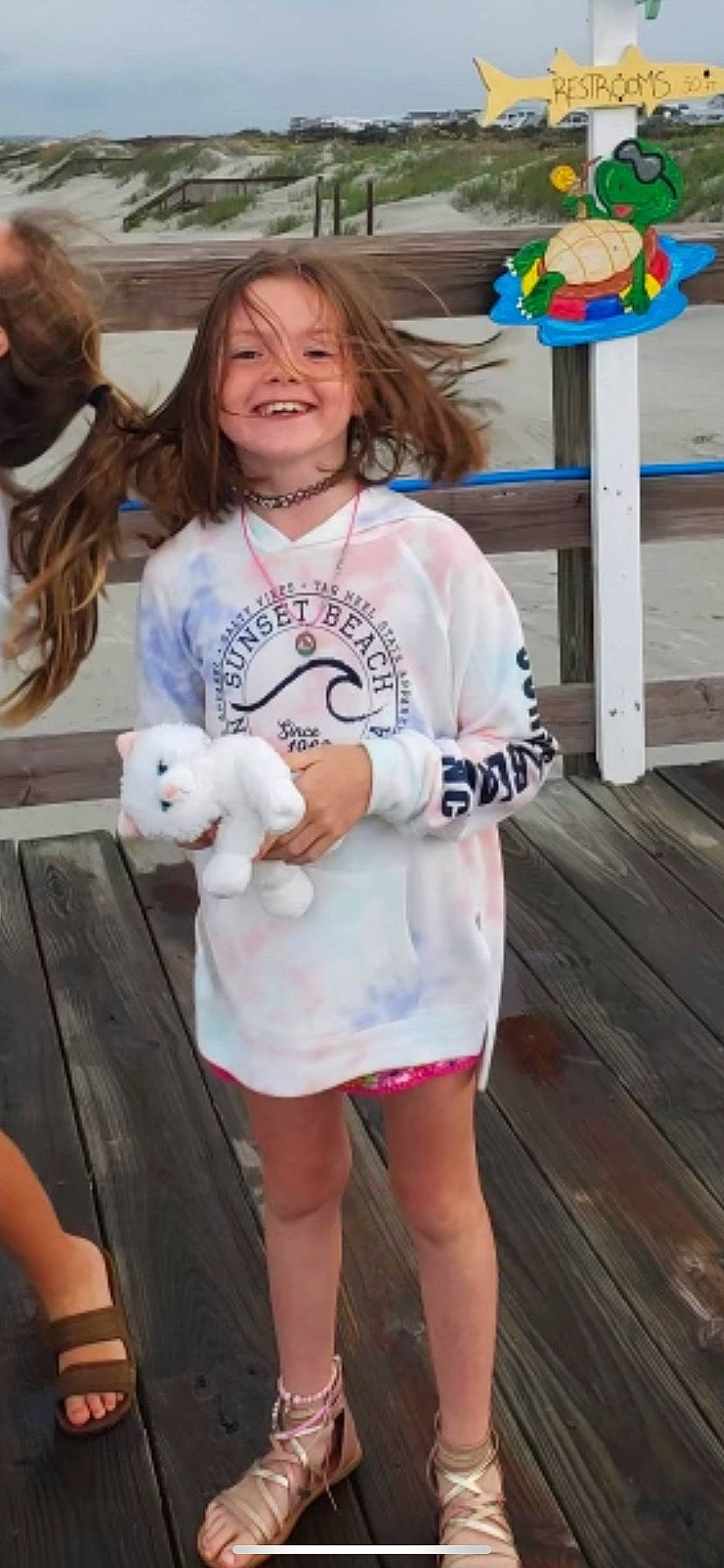 Khloe is registered to the contest to win money with this photo: blond, child, companion_dog, event, fun, fur, happy, hoodie, human_leg, joy, leisure, person, play, recreation, room, sleeve, smile, t_shirt, thigh, toddler