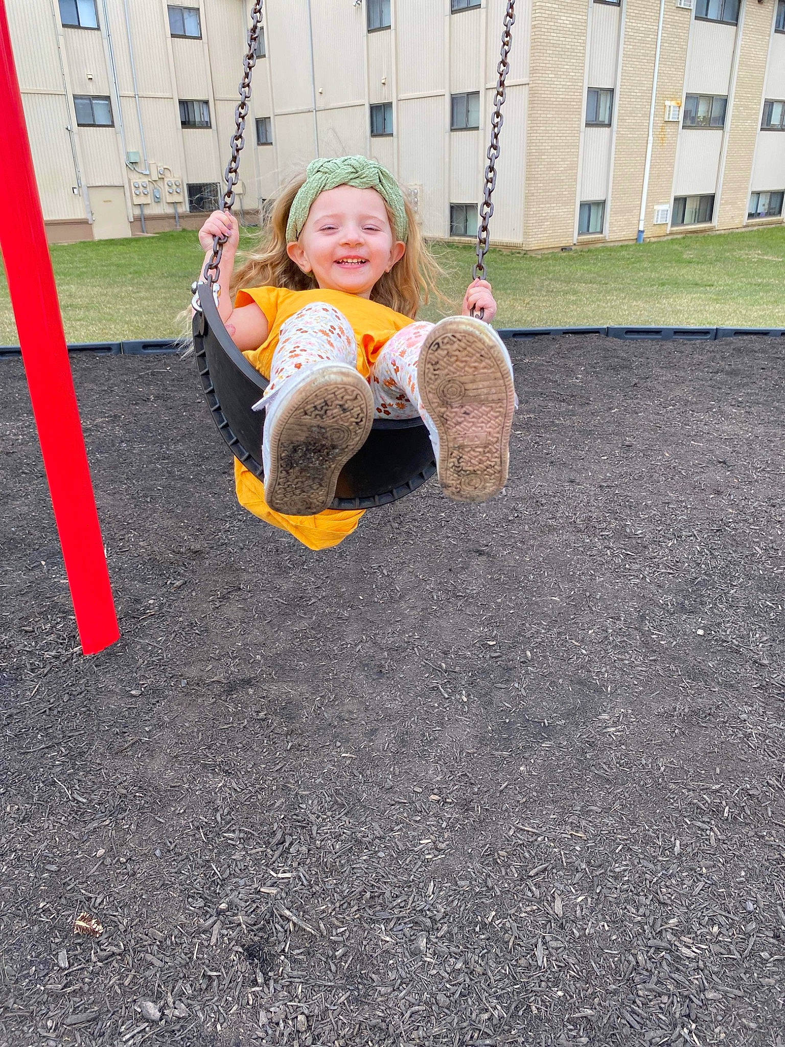 Lucy joined the competition — help win amazing prizes! asphalt, city, flooring, fun, grass, headwear, joy, lawn, leisure, outdoor_play_equipment, people_in_nature, person, playground, recreation, road_surface, sidewalk, sitting, smile, soil, swing