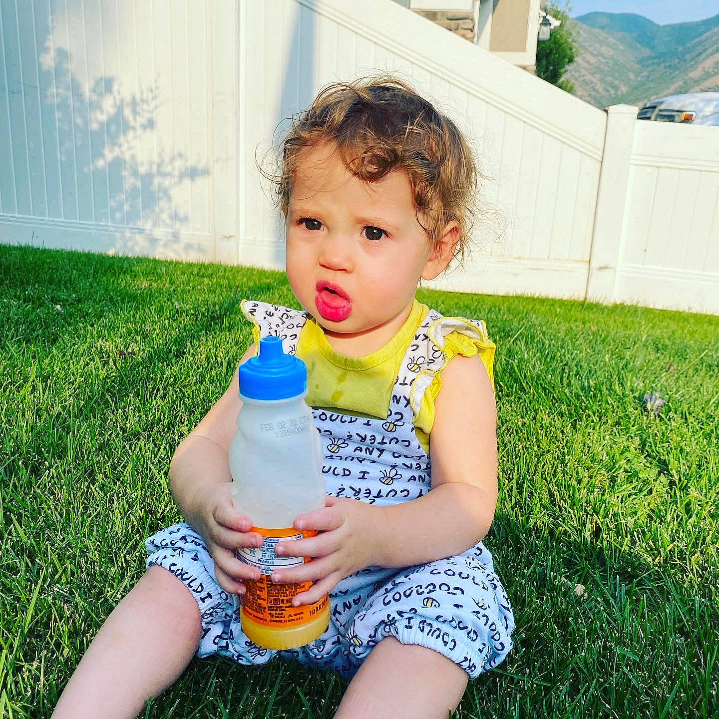 Lacey Jo joined the competition — help win amazing prizes! blue, bottle, bottled_water, drink, drinking_water, drinkware, fun, grass, green, happy, light, people_in_nature, person, photograph, plant, plastic_bottle, standing, sunlight, toddler, water