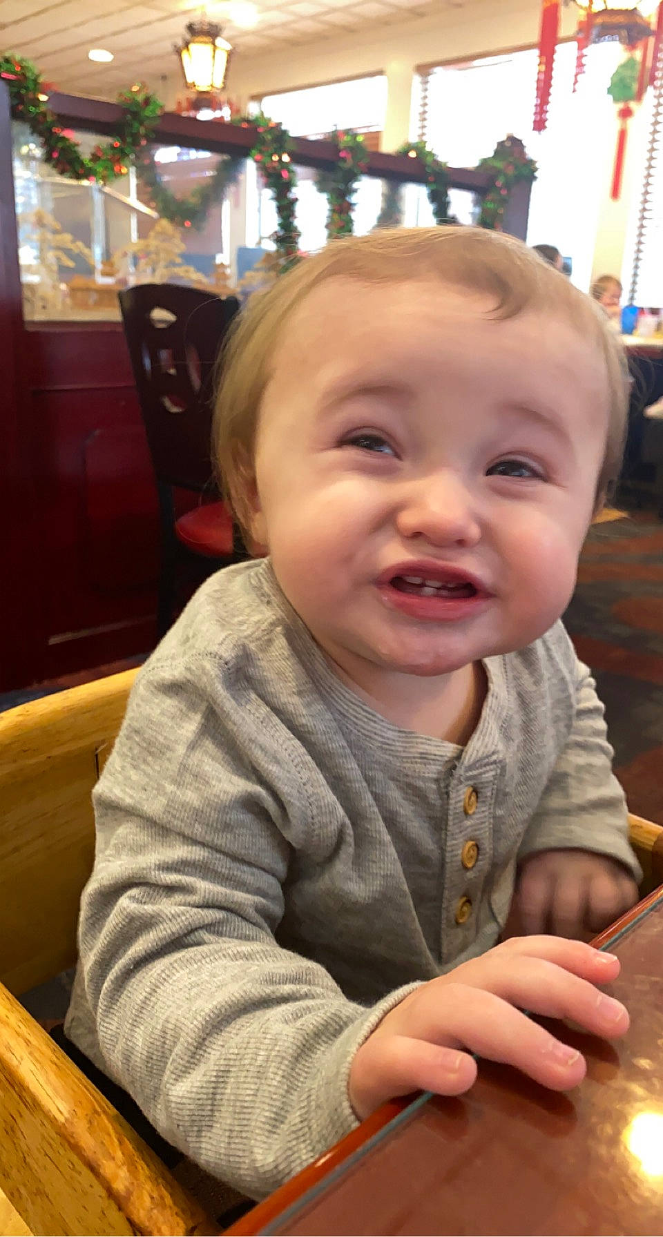 Owen is registered to the contest to win money with this photo: baby, blurred, chair, cheek, child, chin, curtain, event, flooring, fun, happy, iris, laugh, mouth, nose, person, play, sitting, skin, smile