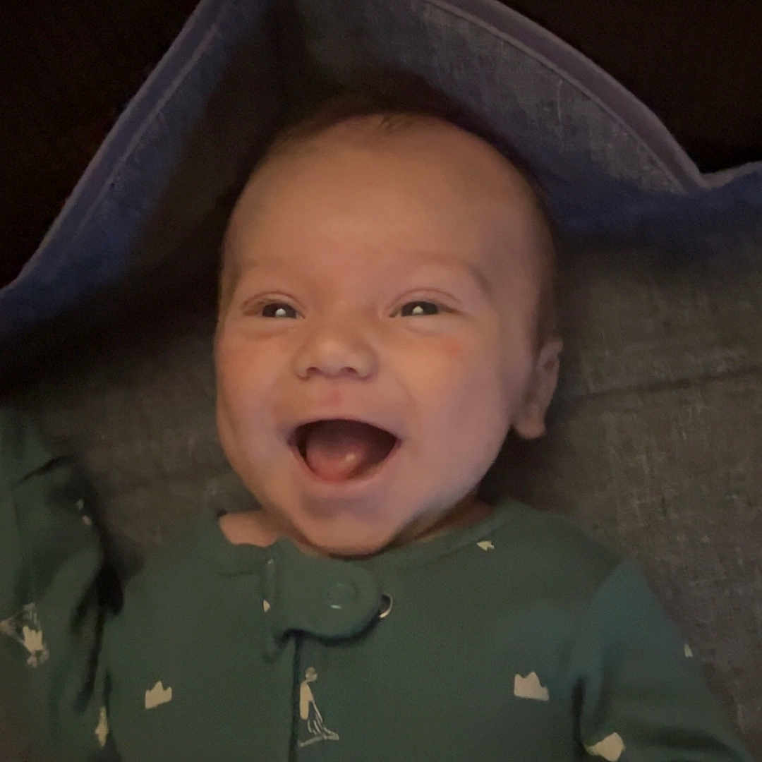 Weldon is registered to the contest to win money with this photo: baby, babylaughing, bodypart, bonnet, clothing, face, happy, hat, head, hood, hoodie, knitwear, laughing, mouth, person, photography, portrait, smile, sweater, sweatshirt