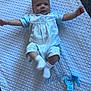 Reggie joined the competition — help win amazing prizes! baby, blue_clothing, bow, carpet_floor, child, cute, embroidery, face, happy, indoor, infant, lying_down, newborn, portrait, small_person, smiling, sock, soft_lighting, textile_texture, white_blanket