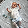 baby, baby_shoes, blanket, blue_clothing, carpet, child, cute, footwear, indoors, infant, looking_up, lying_down, newborn, pacifier, patterned_blanket, peaceful, small_hands, soft_texture, tights, white_clothing