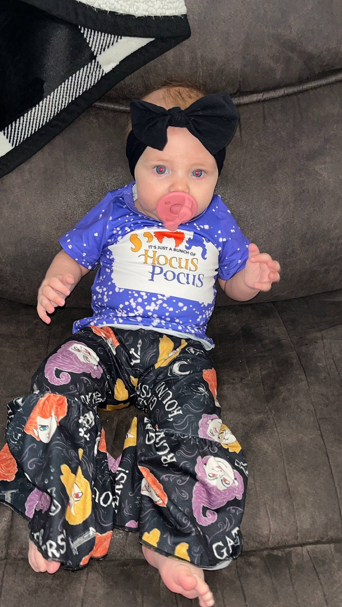 Kamber is registered to the contest to win money with this photo: baby, baby_toddler_clothing, child, costume, electric_blue, fashion_accessory, fun, happy, hat, headwear, human_leg, magenta, pattern, person, personal_protective_equipment, pink, purple, sitting, sleeve, sun_hat