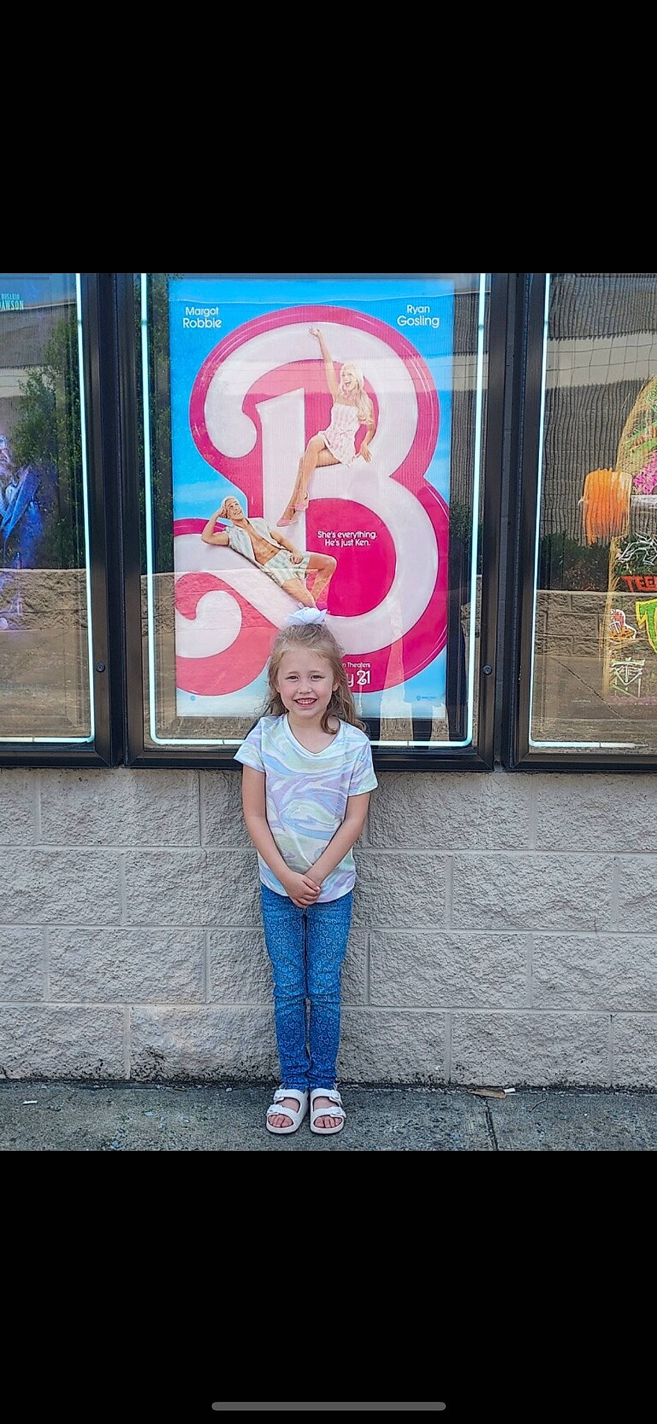 Kenzley is registered to the contest to win money with this photo: advertising, art, city, cool, denim, electric_blue, font, glass, graphics, joy, magenta, person, pink, sign, signage, smile, standing, street, t_shirt, tints_and_shades