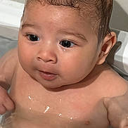Damien joined the competition — help win amazing prizes! baby, water, bath, wet_hair, skin, face, eyes, arm, chest, infant, cute, child, young, indoors, human, person, expression, fingers, head, closeup