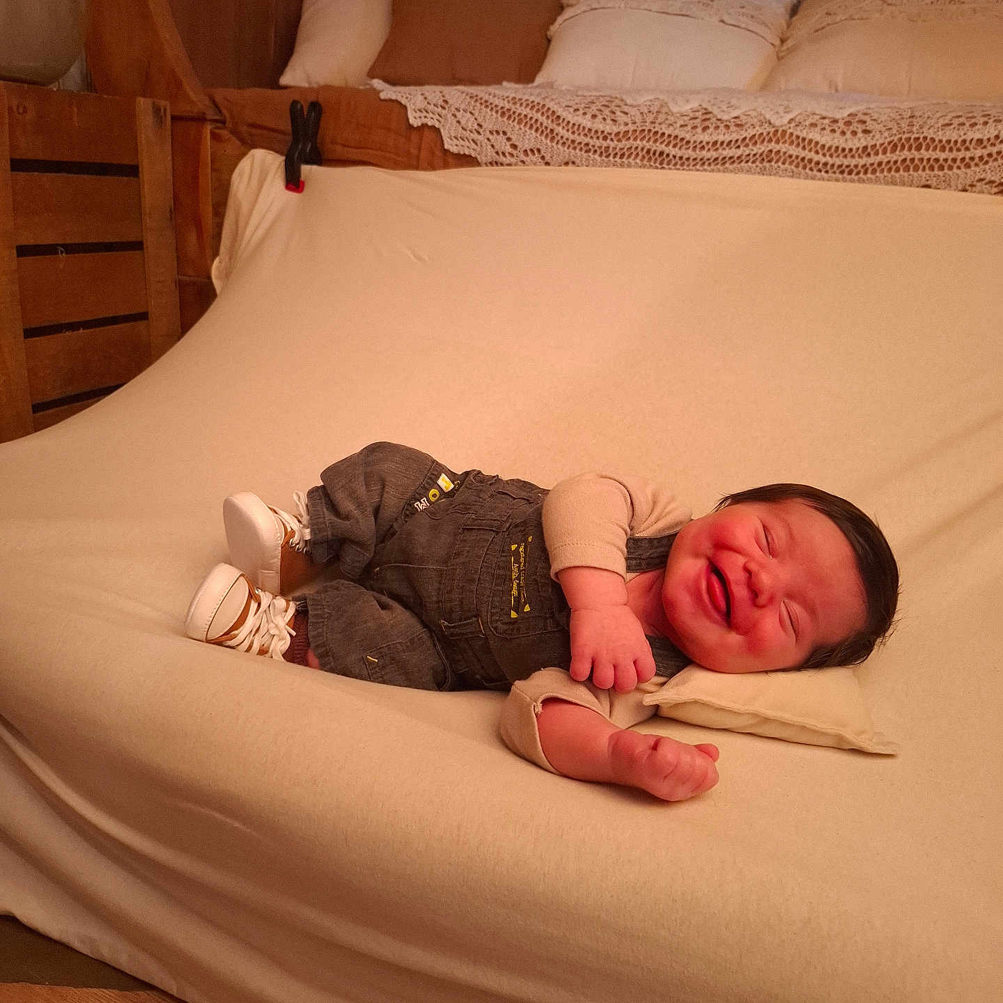 Kurtis a rejoint le concours — aidez-le/la à gagner de superbes lots ! baby, smiling, infant, couch, pillow, overalls, shoes, wooden_furniture, cushions, indoor, happy, child, person, portrait, cozy, home, fabric, resting, cute, warm_lighting