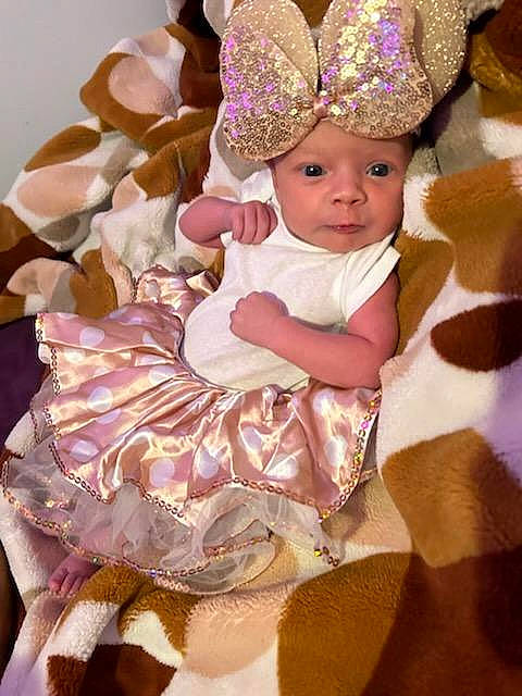 Alaia is registered to the contest to win money with this photo: baby, baby_products, baby_toddler_clothing, chair, child, costume_hat, crown, dress, event, fashion_accessory, fashion_design, hair_accessory, headband, headgear, headpiece, headwear, jewellery, peach, person, pink