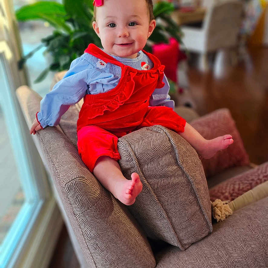 Charlie is registered to the contest to win money with this photo: architecture, baby, building, chair, couch, cushion, face, flower, flowerarrangement, furniture, head, homedecor, indoors, interiordesign, livingroom, person, photography, plant, portrait, room