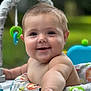Everly is registered to the contest to win money with this photo: baby, child, smiling, face, arm, toy, baby_seat, colorful, outdoor, nature, green, cute, happy, infant, closeup, portrait, playful, skin, young, childhood