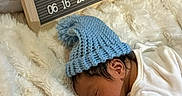 Sonny joined the competition — help win amazing prizes! newborn, baby, sleeping, blue_hat, blanket, letter_board, birthday, soft_texture, white, wooden_frame, infant, cozy, cute, resting, indoor, person, headwear, announcement, celebration, closeup