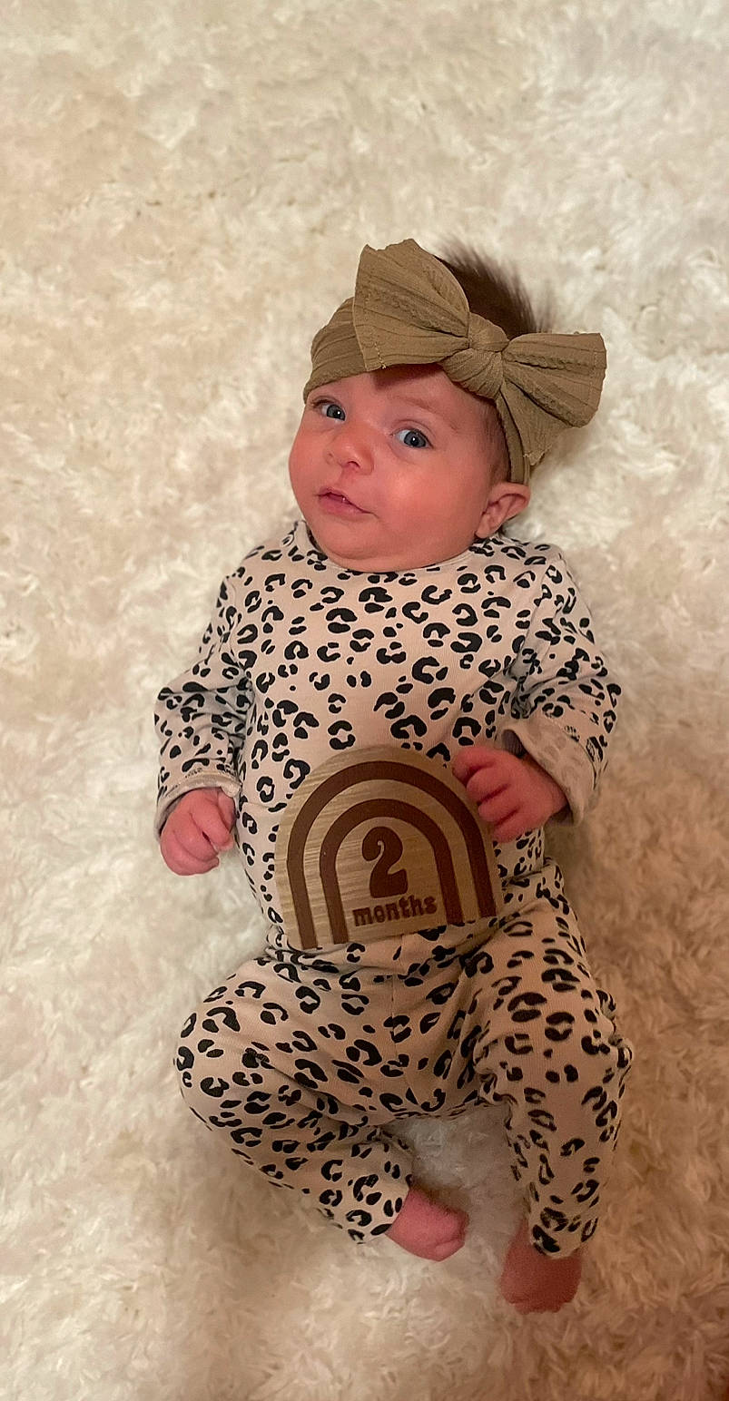 Frankie joined the competition — help win amazing prizes! art, baby, baby_toddler_clothing, cap, cheek, child, comfort, eye, face, facial_expression, head, headgear, headwear, nose, outerwear, pattern, person, skin, sleeve, textile