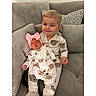 Tyler is registered to the contest to win money with this photo: baby, child, children, couch, cozy, cushions, cute, face, family, home, indoor, infant, matching_outfits, pajamas, person, pink_bow, siblings, sleeping, smile, toddler