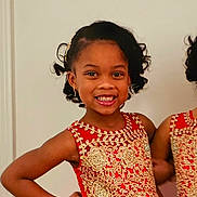Jamie is registered to the contest to win money with this photo: child, girl, smiling, red_dress, gold_embroidery, curly_hair, earrings, posing, happy, portrait, indoor, fashion, elegant, confident, cute, young_girl, celebration, formal_wear, standing, hairstyle