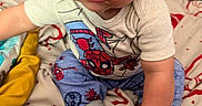 Jamaree joined the competition — help win amazing prizes! baby, child, spiderman, hat, clothing, bed, blanket, sock, person, indoor, cute, infant, smiling, toddler, hand, face, eyes, furniture, colorful, soft