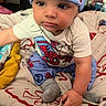 baby, child, spiderman, hat, clothing, bed, blanket, sock, person, indoor, cute, infant, smiling, toddler, hand, face, eyes, furniture, colorful, soft