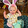 Evalynn joined the competition — help win amazing prizes! baby, bunny_ears, pink_bow, smiling, indoor, blue_blanket, stuffed_toy, wooden_floor, floral_clothing, child, cute, happy, sitting, toy, headwear, face, infant, plush_toy, decor, person