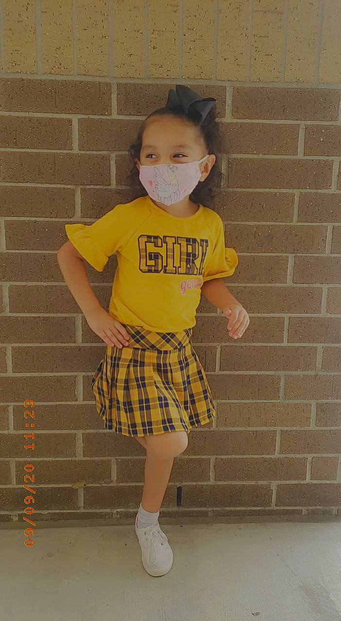 Nikkole Guadalupe Zabala is registered to the contest to win money with this photo: baby_toddler_clothing, brick, face, fashion_design, happy, human_body, human_leg, knee, neck, pattern, person, plaid, shoulder, sleeve, street_fashion, t_shirt, tartan, thigh, toddler, waist