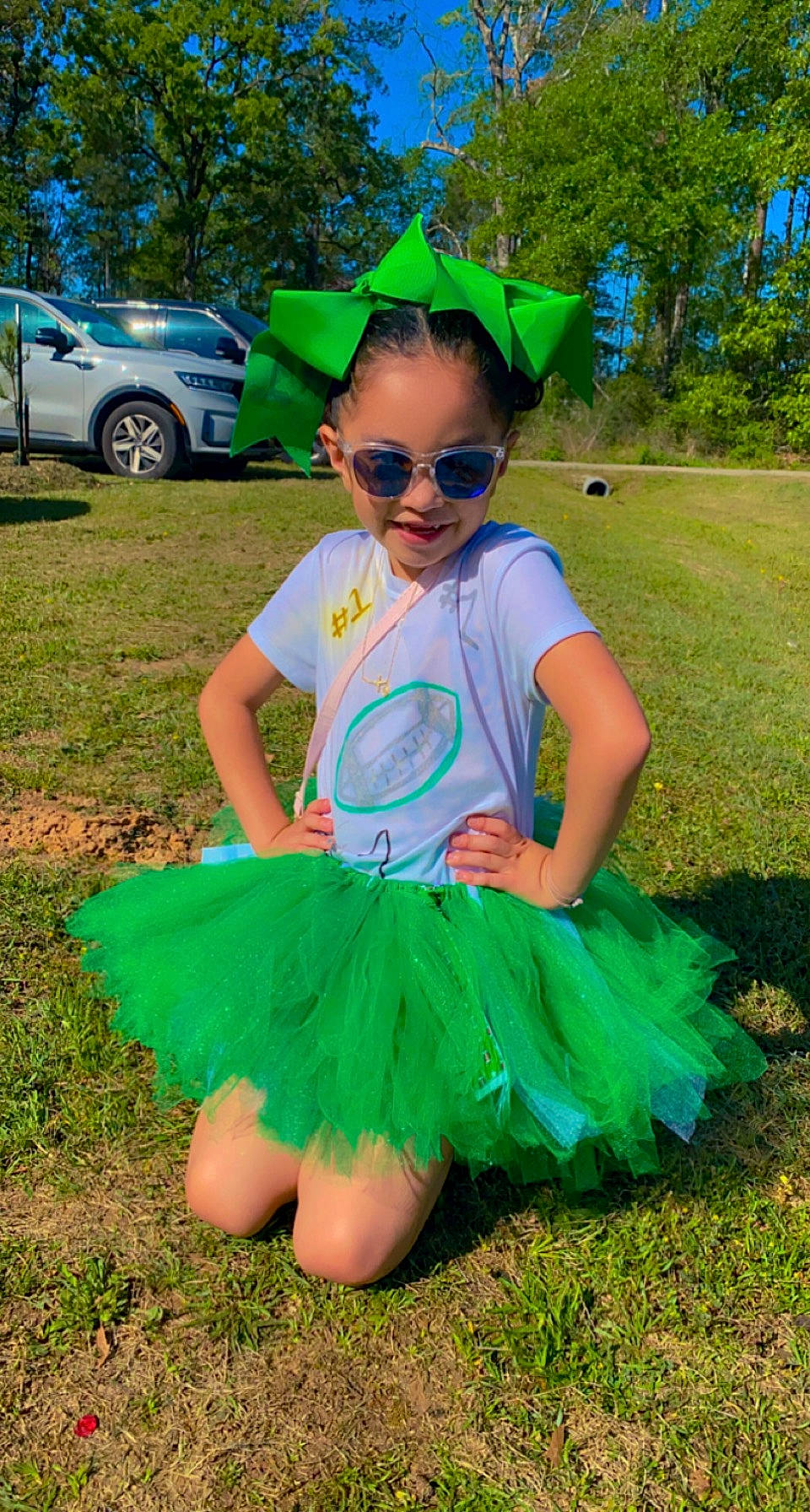 Nikkole joined the competition — help win amazing prizes! baby_toddler_clothing, blue, costume_hat, dress, eyewear, glasses, goggles, grass, green, happy, headgear, joy, leaf, person, pink, plant, smile, summer, sunglasses, tire