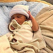 Mias Abram joined the competition — help win amazing prizes! baby, newborn, sleeping, pacifier, blanket, hat, infant, cozy, soft, bed, swaddled, cute, peaceful, child, person, resting, indoor, clothing, striped, warm
