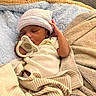 baby, newborn, sleeping, pacifier, blanket, hat, infant, cozy, soft, bed, swaddled, cute, peaceful, child, person, resting, indoor, clothing, striped, warm